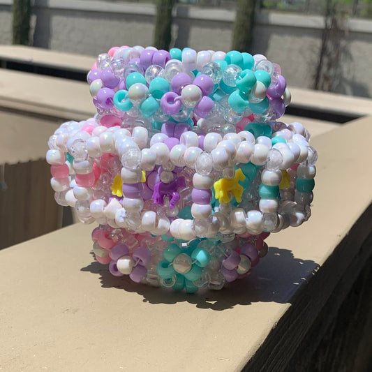 Pastel pink, blue, purple, and yellow Carousel Themed Kandi rotating cuff with pearl accents and matching horse details